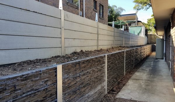 well maintained retaining wall with steel posts